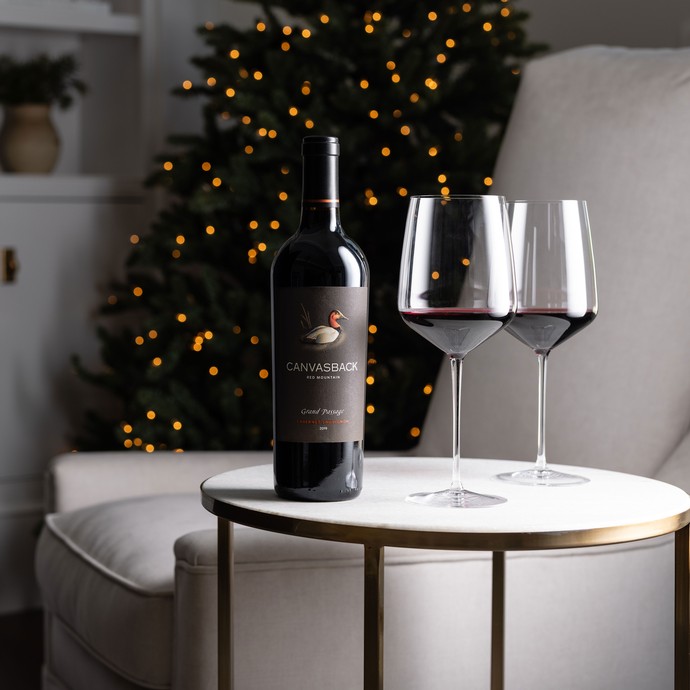 Canvasback wine and glasses in front of a Christmas tree